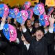 Students at the Hoyonomori Gakuen School cheer the selection of the 2020 Olympic and Paralympic mascots.